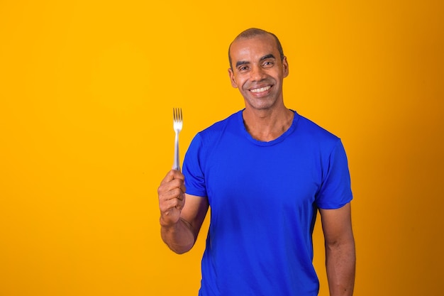 Hungry man holding a fork