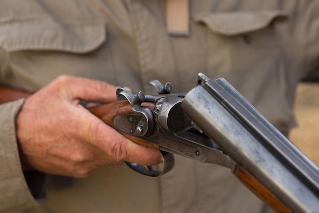 Hunter man in camouflage with a gun during the hunt in search of wild birds or game Autumn hunting