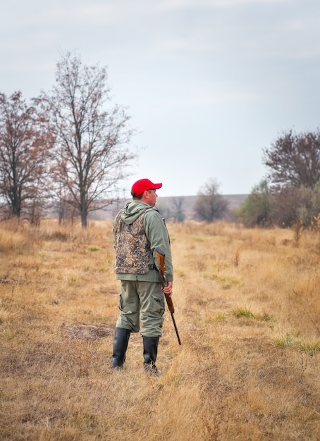 Hunter moving with shotgun looking for prey