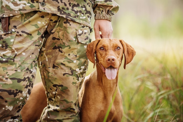 Hunter with a dog on the forest