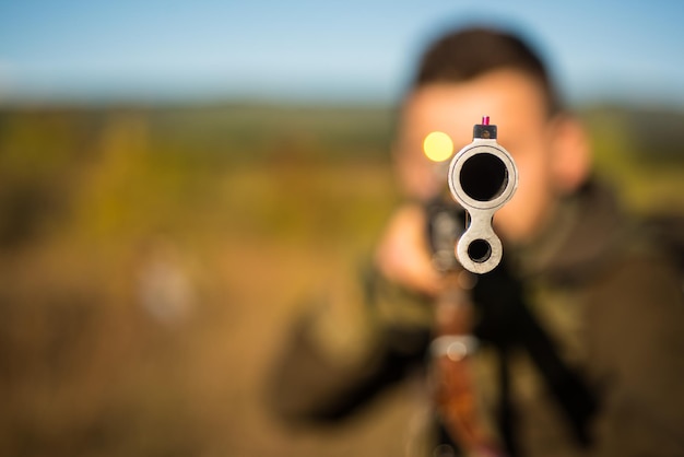 총의 사냥 배럴에 산탄총을 든 사냥꾼은 텍스트 사냥 총을 위한 복사 공간을 추적합니다.