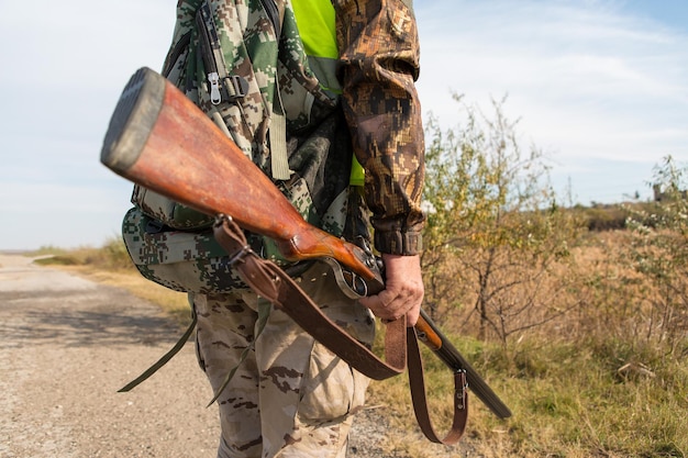 Hunters with a german drathaar and spaniel pigeon hunting with dogs in reflective vests