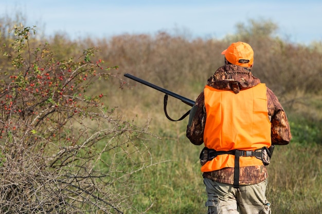 Hunters with a german drathaar and spaniel, pigeon hunting with dogs in reflective vests