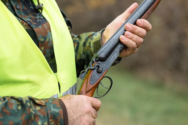 Hunters with a german drathaar and spaniel, pigeon hunting with dogs in reflective vests