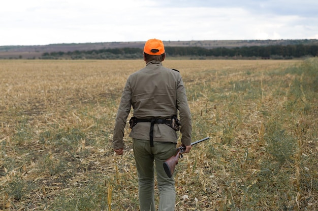 Hunters with a german drathaar and spaniel, pigeon hunting with dogs in reflective vests