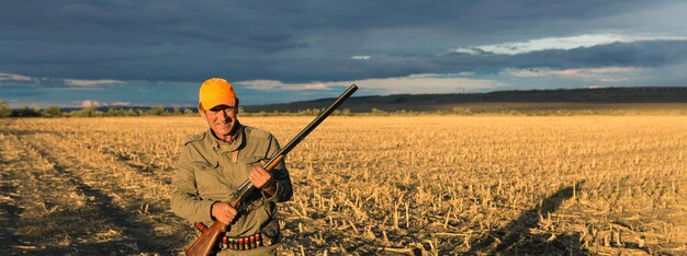 Hunters with a german drathaar and spaniel, pigeon hunting with dogs in reflective vests