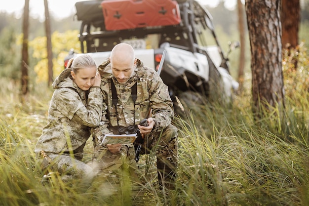 Hunters with Rifle and Four Wheeler Tire in forest