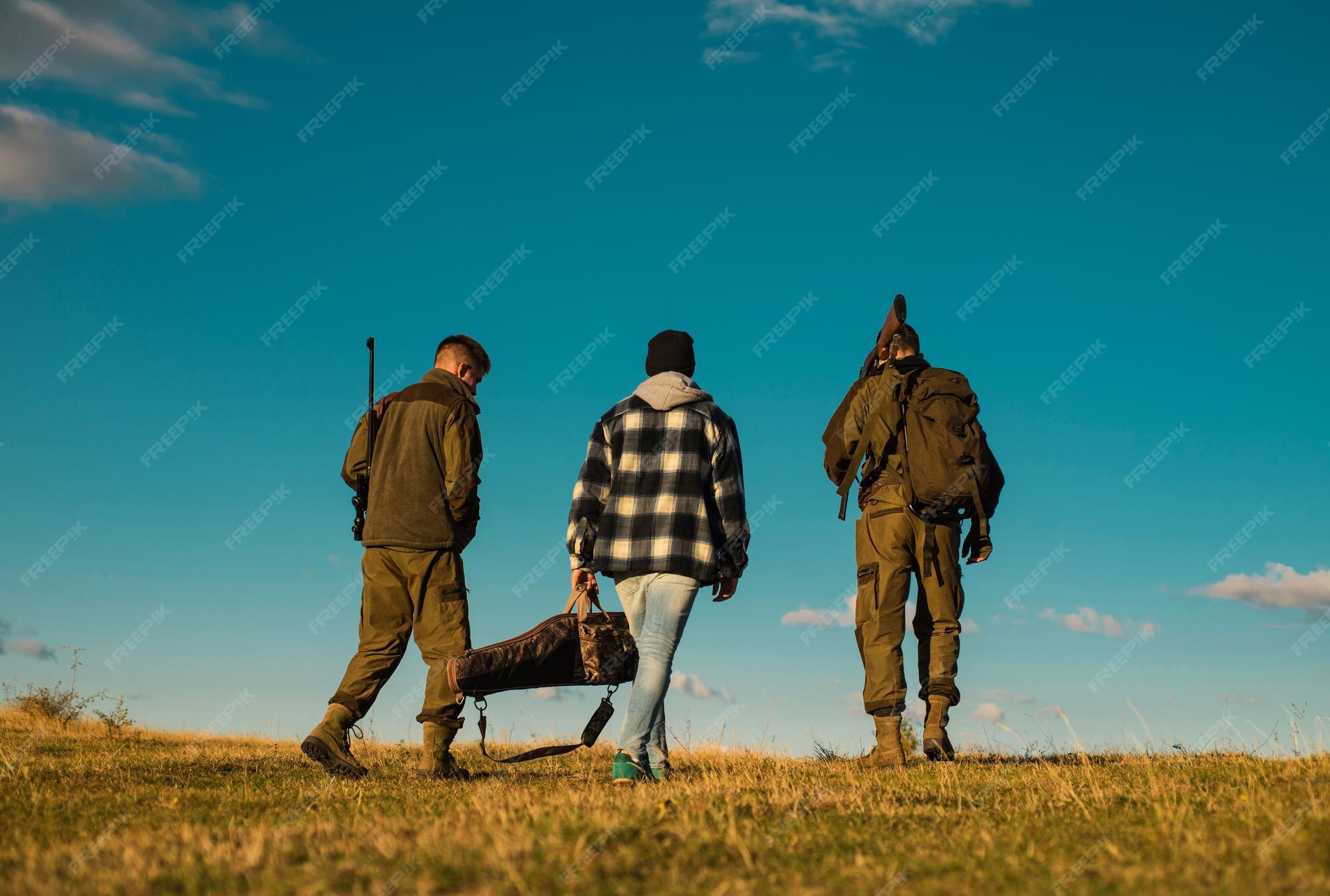 Premium Photo Hunters with shotgun gun on hunt hunting gear hunting