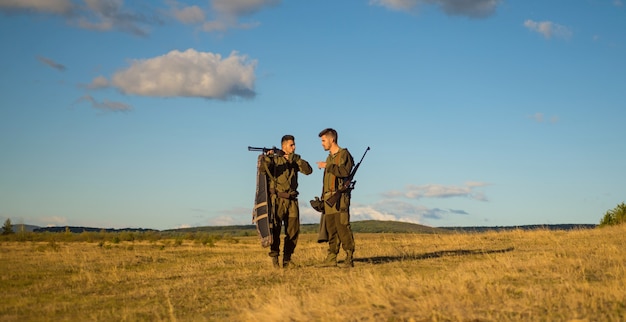 Hunters with shotgun guns on hunting season