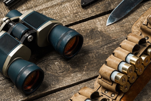 Hunting equipment binoculars on wooden close up