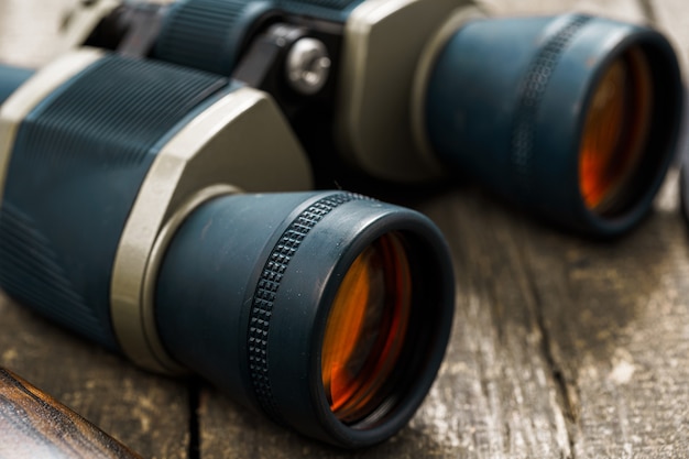 Hunting equipment binoculars on wooden close up