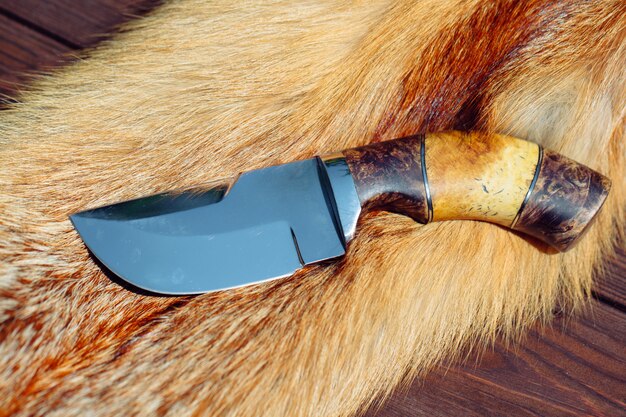 Hunting knife on red fox fur.