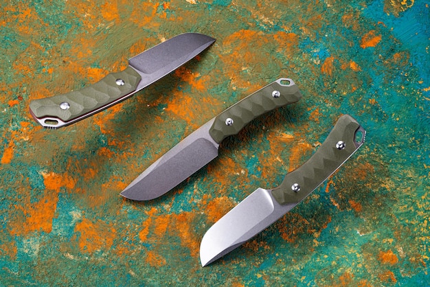 Photo hunting knife with a fixed blade knife from three angles knife with green handle levitation