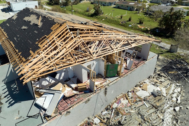 Hurricane Ian destroyed house roof and walls in Florida residential area Natural disaster and its consequences