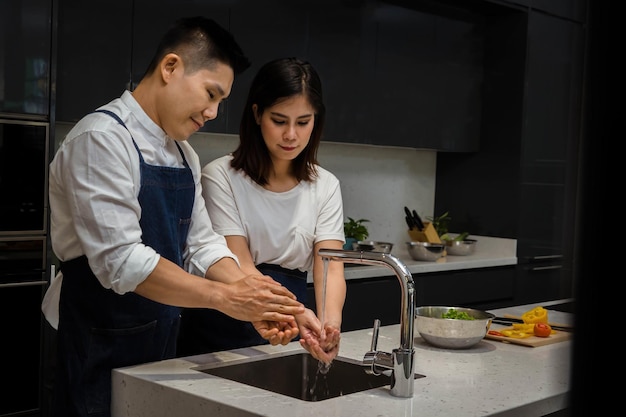 husban and wife are washing hand for protection against virus and infection