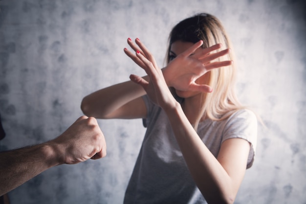 Husband assaulting his wife on a gray