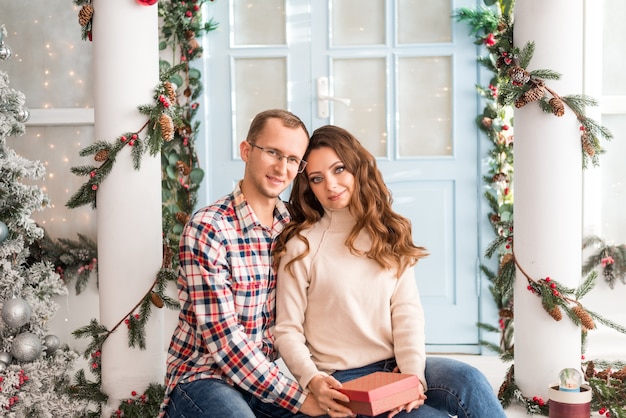 Husband congratulates his wife on the New Year and Christmas and gives gifts