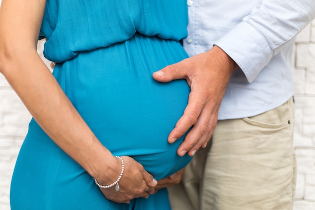 Husband holding pregnant belly's wife