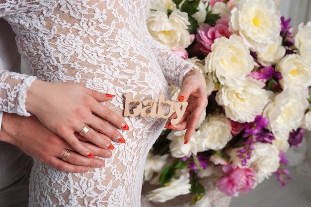 Husband hugging his pregnant wife in the  color