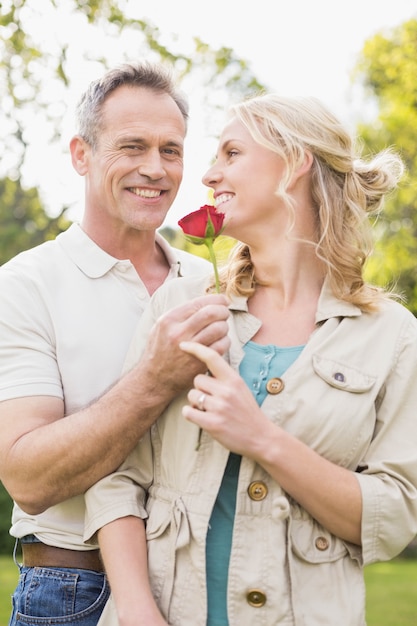 Husband offering a rose to wife outside