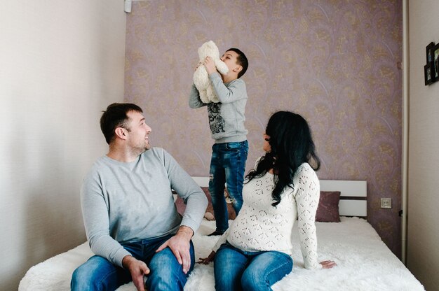 Husband, pregnant wife and son at home