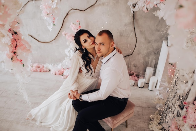 Husband and wife couple hugging at the photo session in studio