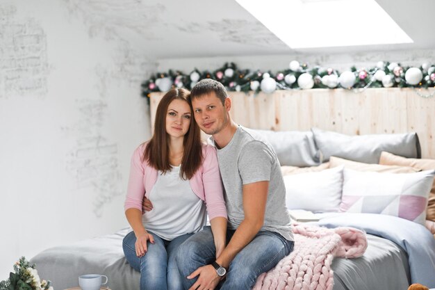 Husband and wife hugging on the background of Christmas decorations 1