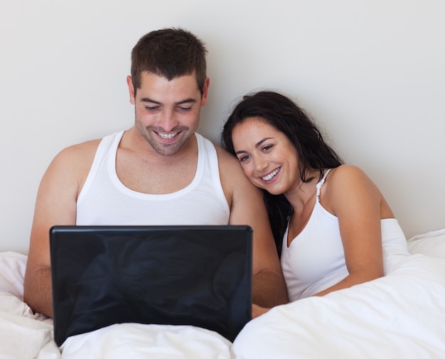 Husband and wife lying in bed 