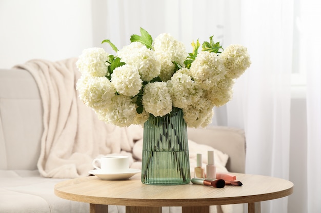 hydrangea flowers, cup of coffee and cosmetics