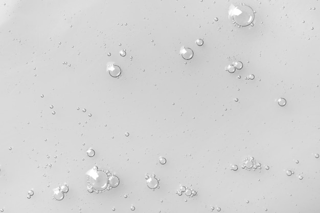 Hydrophilic oil with bubbles on white background top view