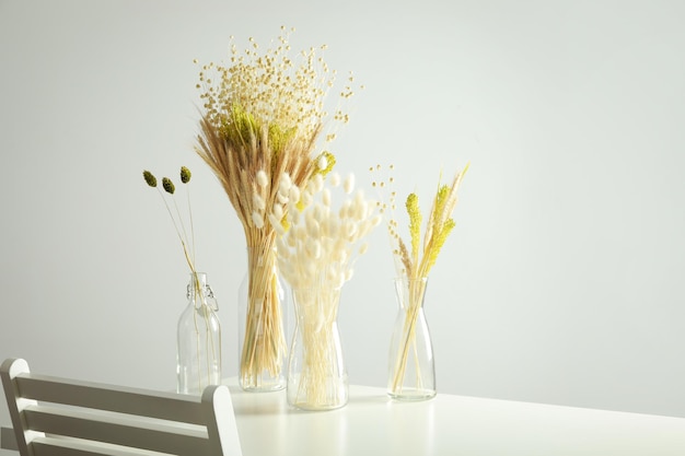 Hygge concept dried flowers in vases on table