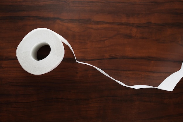 Hygiene and cleanliness Roll of white toilet paper on wooden background with copy space