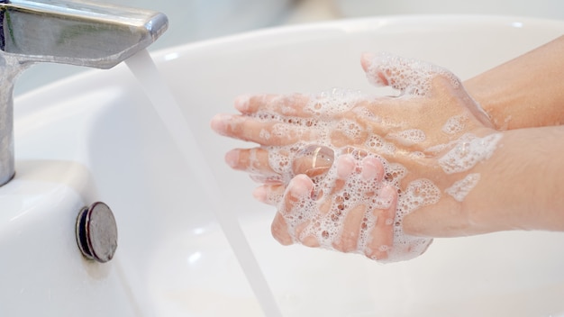 Hygiene concept Wash your hands with soap in the sinkCover for virus protection