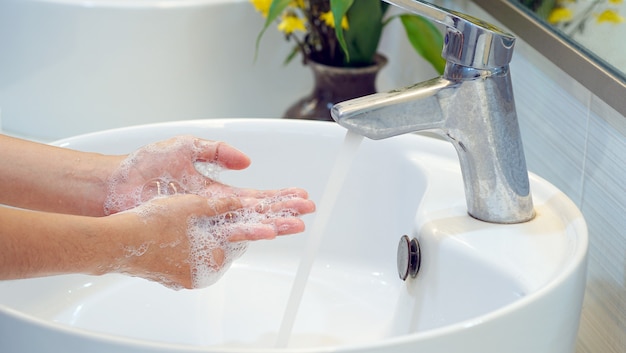 Hygiene concept Wash your hands with soap in the sinkCover for virus protection