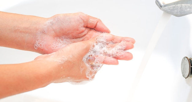 Hygiene concept Wash your hands with soap in the sinkCover for virus protection