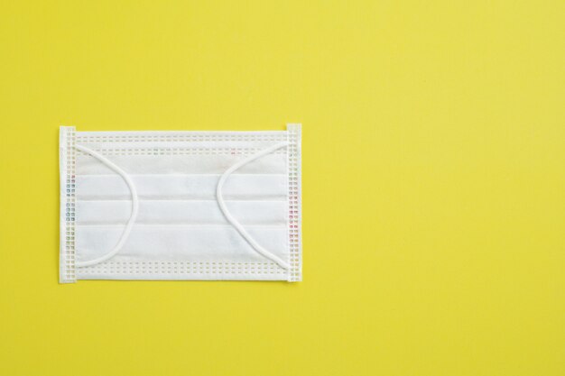 Hygiene face mask on yellow background