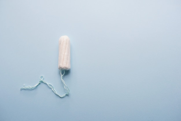 Hygienic tampon on a blue background. copy space