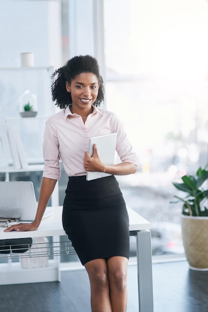 I always carry my handiest device with me Portrait of a young businesswoman holding a digital tablet in an office