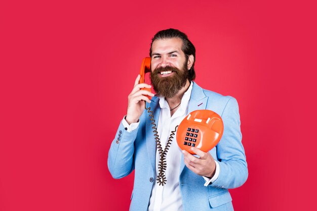 I am listening call and conversation modern and vintage technology bearded hipster use retro telephone communication concept brutal handsome man with moustache speak on phone