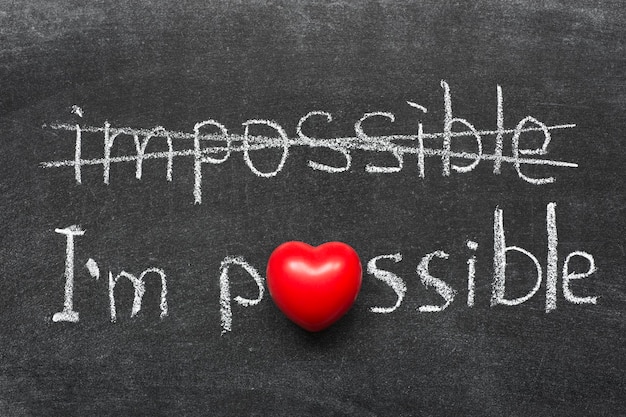 I am possible concept handwritten on blackboard with heart symbol instead of O