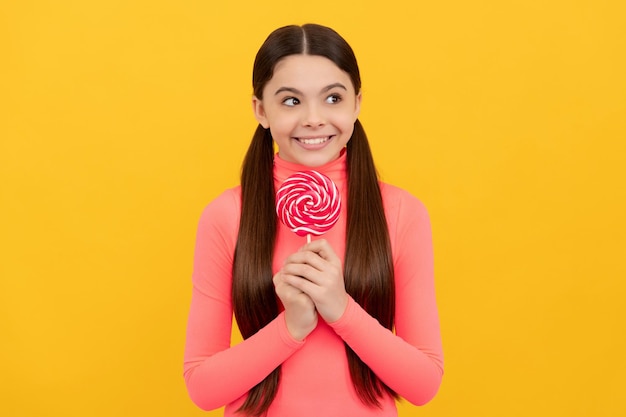 I am so glad sweet tooth yummy happy girl hold lollipop lollipop child kid with long hair hold lollypop sugar candy on stick caramel candy shop sweet childhood life teen dental care