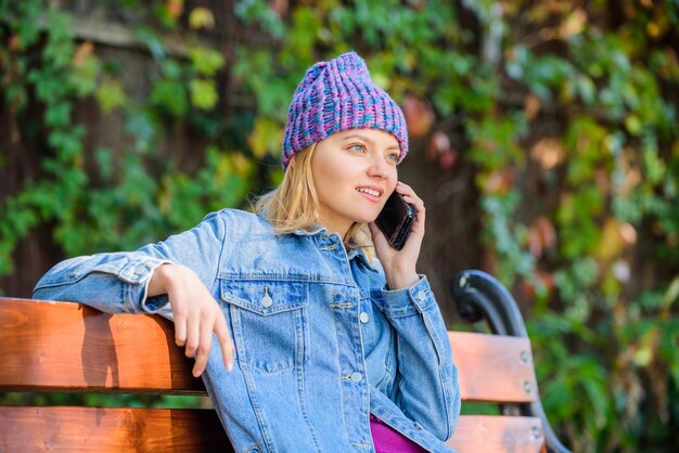 I am waiting for you in park Girl busy with smartphone green nature background Woman having mobile conversation Girl smartphone call friend Stay touch with modern smartphone Mobile call concept