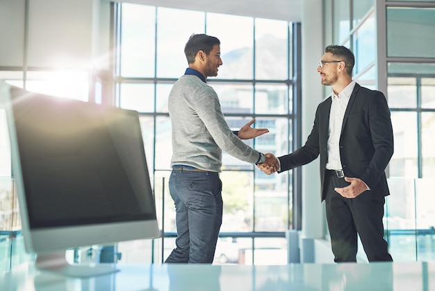 I cant thank you enough for this opportunity. Shot of two businessmen shaking hands together in an office.