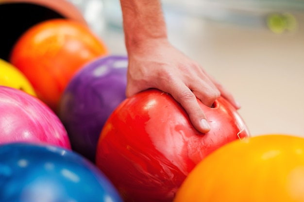 I choose this one. Close-up of a hand holding bowling ball