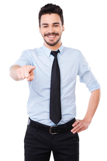 I choose you! Handsome young man in shirt and tie pointing you and smiling 