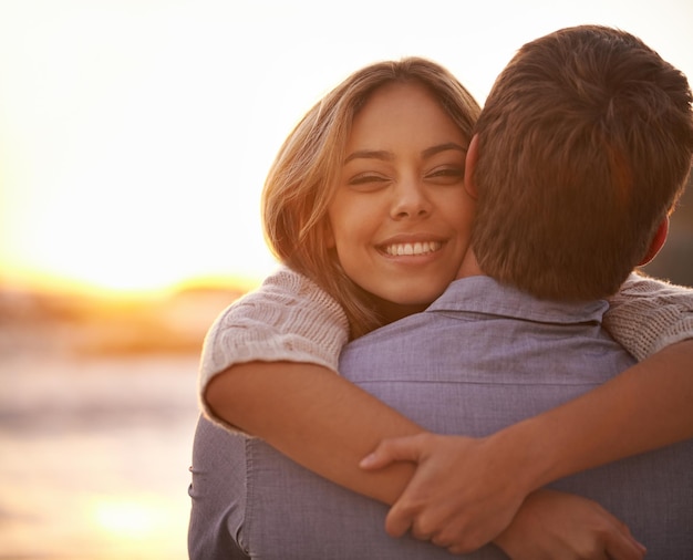 I could hug you forever Portrait of a happy young couple enjoying a romantic embrace on the beach at sunset