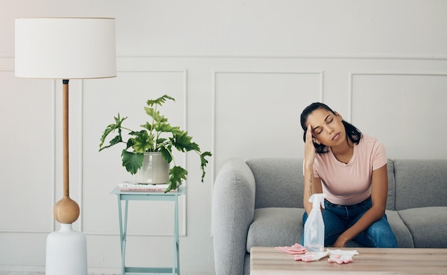 Photo i could do with a little help around the house shot of a woman looking stressed while busy cleaning at home