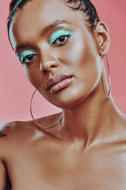 I dared to be different Shot of a beautiful young woman wearing makeup while posing against a pink background