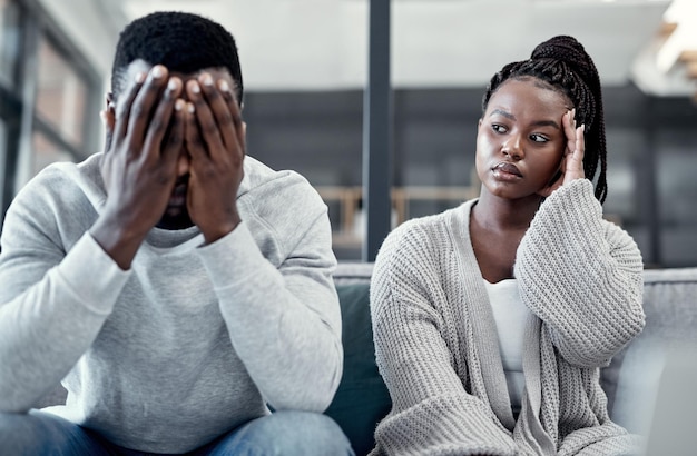 I dont even care anymore Shot of a young couple ignoring each other after having an argument on the sofa at home