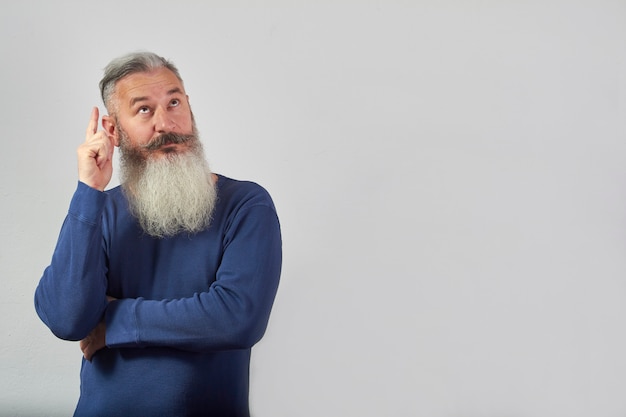 I have an idea concept, portrait of mature gray-haired bearded man